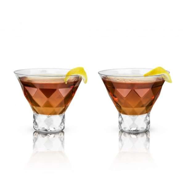 2 Crystal Faceted Martini Glasses Filled With Alcoholic Beverage And Sliced Lemon