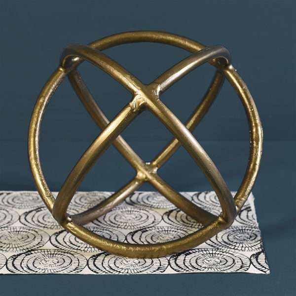 Brass Sphere Sitting On Black And White Cloth